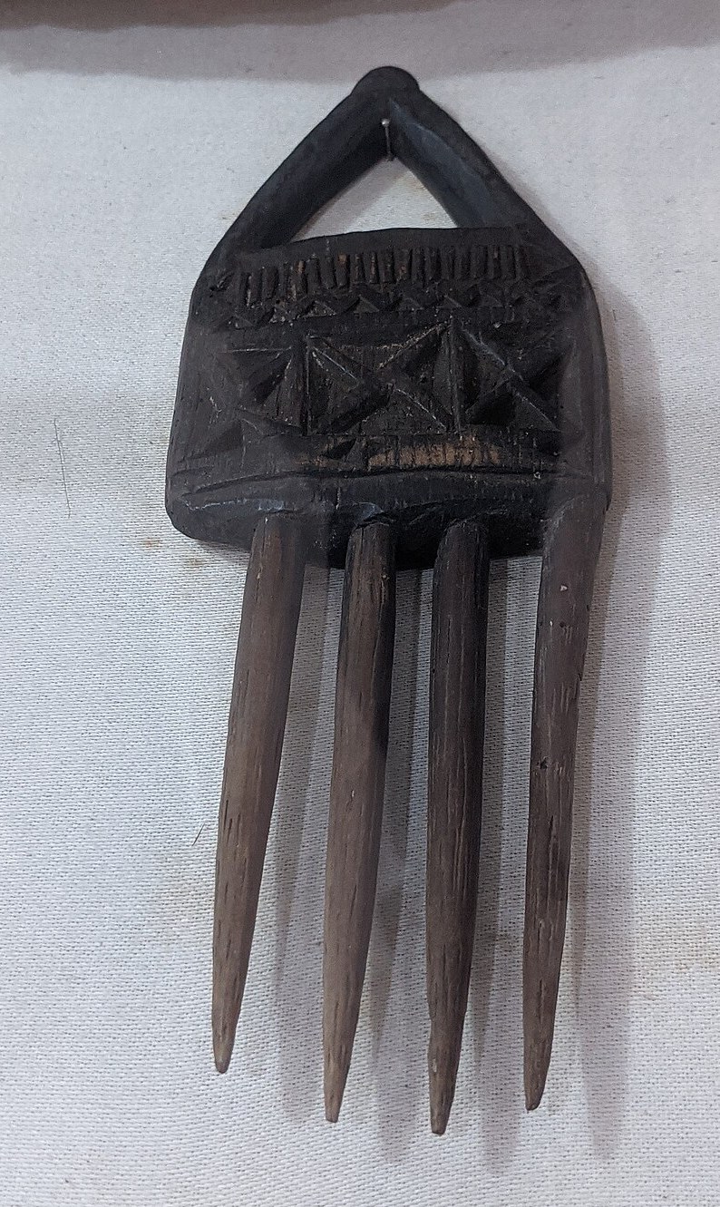 A carved wooden hair comb
